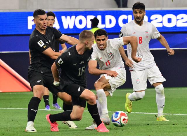 New Zealand's defender #16 Finn Surman and Iran's forward #11 Ali Alipour fight for the ball during the 2026 World Cup Group G football match between Iran and New Zealand at Los Angeles Stadium in Inglewood on June 15, 2026.  (Photo by Frederic J. Brown / AFP)