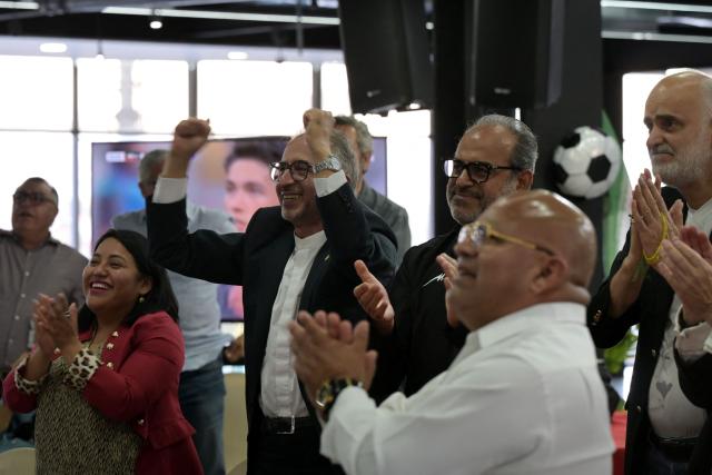 Iran's ambassador to Mexico Abolfazl Pasandideh (2nd-L) and First Vice President of the Islamic Republic of Iran Football Federation Mehdi Mohammad Nabi(R) celebrate as they watch the 2026 World Cup Group G football match between Iran and New Zealand at the Chamber of Commerce in Tijuana, Mexico on June 15, 2026. (Photo by Guillermo Arias / AFP)