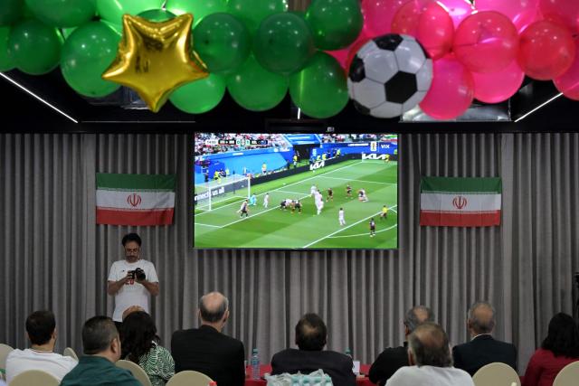 Iran's ambassador to Mexico Abolfazl Pasandideh, First Vice President of the Islamic Republic of Iran Football Federation Mehdi Mohammad Nabi and Iranian fans watch the 2026 World Cup Group G football match between Iran and New Zealand at the Chamber of Commerce in Tijuana, Mexico on June 15, 2026. (Photo by Guillermo Arias / AFP)