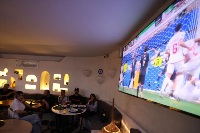 Iranians watch the 2026 World Cup football tournament match between Iran and New Zealand at a cafe in Tehran, Iran, on June 16, 2026. (Photo by ATTA KENARE / AFP)
