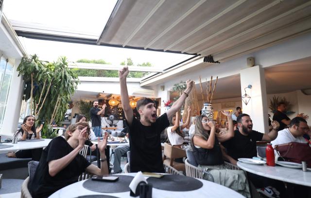 Iranians react while watching the 2026 World Cup football tournament match between Iran and New Zealand at a cafe in Tehran, Iran, on June 16, 2026. (Photo by ATTA KENARE / AFP) / Israel OUT/NO Access Israel Media/Persian Language TV Stations Outside Iran/Strictly No Access BBC Persian/VOA Persian/Manoto TV/Iran International TV