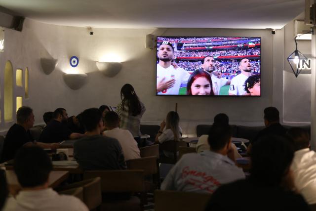 Iranians watch the 2026 World Cup football tournament match between Iran and New Zealand at a cafe in Tehran, Iran, on June 16, 2026. (Photo by ATTA KENARE / AFP)