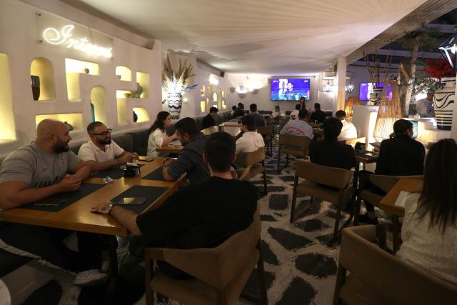 Iranians watch the 2026 World Cup football tournament match between Iran and New Zealand at a cafe in Tehran, Iran, on June 16, 2026. (Photo by ATTA KENARE / AFP)