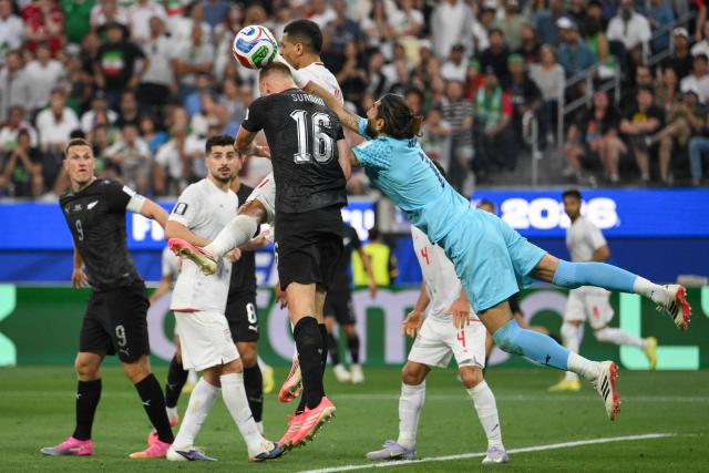 Iran's goalkeeper #01 Alireza Beiranvand clears the ball past New Zealand's defender #16 Finn Surman during the 2026 World Cup Group G football match between Iran and New Zealand at Los Angeles Stadium in Inglewood on June 15, 2026.  (Photo by Patrick T. Fallon / AFP)