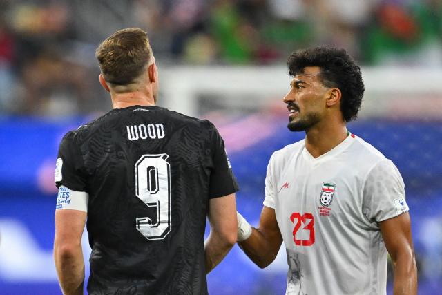 New Zealand's forward #09 Chris Wood and Iran's defender #03 Ehsan Hajsafi talk during the 2026 World Cup Group G football match between Iran and New Zealand at Los Angeles Stadium in Inglewood on June 15, 2026.  (Photo by Patrick T. Fallon / AFP)