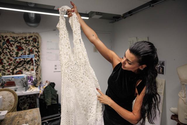 (FILES) Spanish designer, creative director and stylist, Maria Bernad, creator of "Les Fleurs studio" works on an upcycled fashion piece at her atelier in Paris on May 5, 2026. Lace is making a big comeback in fashion, bringing a touch of craftsmanship and delicacy, and this traditional fabric is now even being recycled to create unique pieces worn by stars such as Beyonce and Rosalia. (Photo by SIMON WOHLFAHRT / AFP)