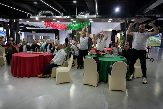 Iran's ambassador to Mexico Abolfazl Pasandideh, First Vice President of the Islamic Republic of Iran Football Federation Mehdi Mohammad Nabi and Iranian fans celebrate as they watch the 2026 World Cup Group G football match between Iran and New Zealand at the Chamber of Commerce in Tijuana, Mexico on June 15, 2026. (Photo by Guillermo Arias / AFP)
