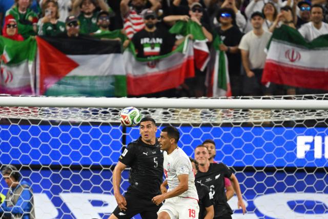 New Zealand's defender #05 Michael Boxall and Iran's defender #19 Ali Nemati look at the ball during the 2026 World Cup Group G football match between Iran and New Zealand at Los Angeles Stadium in Inglewood on June 15, 2026.  (Photo by Patrick T. Fallon / AFP)