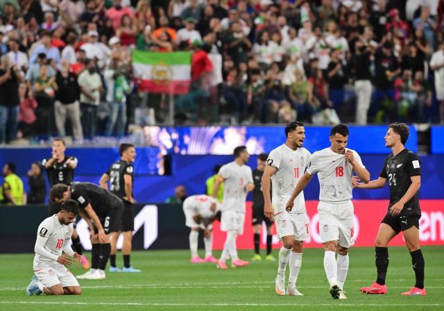Iran's midfielder #10 Mehdi Ghayedi, forward #11 Ali Alipour, forward #18 Amirhossein Hosseinzadeh, and New Zealand's defender #24 Callan Elliot react after the 2026 World Cup Group G football match between Iran and New Zealand at Los Angeles Stadium in Inglewood on June 15, 2026.  (Photo by Frederic J. Brown / AFP)