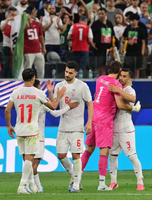 Iran's midfielder #06 Saeid Ezatolahi and teammates react after the 2026 World Cup Group G football match between Iran and New Zealand at Los Angeles Stadium in Inglewood on June 15, 2026.  (Photo by Frederic J. Brown / AFP)