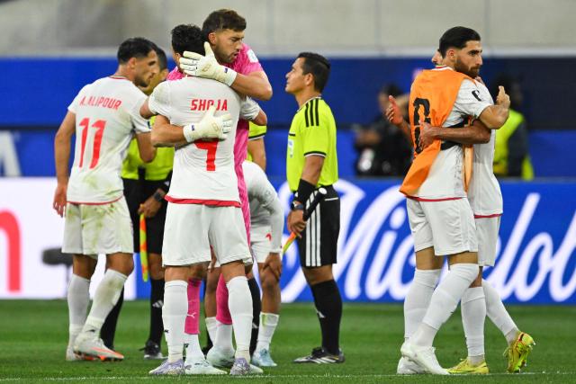 Iran's players hug each other after the 2026 World Cup Group G football match between Iran and New Zealand at Los Angeles Stadium in Inglewood on June 15, 2026.  (Photo by Patrick T. Fallon / AFP)