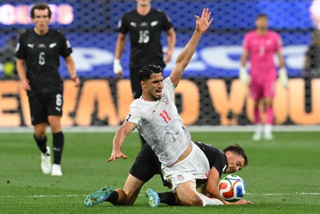 Iran's forward #11 Ali Alipour falls on the ground during the 2026 World Cup Group G football match between Iran and New Zealand at Los Angeles Stadium in Inglewood on June 15, 2026.  (Photo by Patrick T. Fallon / AFP)