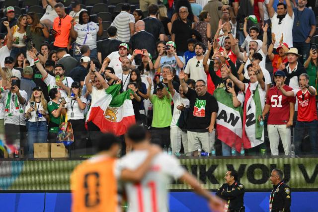 Iranian fans greet the players after the 2026 World Cup Group G football match between Iran and New Zealand at Los Angeles Stadium in Inglewood on June 15, 2026.  (Photo by Patrick T. Fallon / AFP)