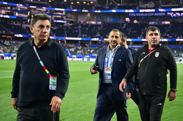Iran's head coach Amir Ghalenoei (L) walks out the pitch after the 2026 World Cup Group G football match between Iran and New Zealand at Los Angeles Stadium in Inglewood on June 15, 2026.  (Photo by Frederic J. Brown / AFP)