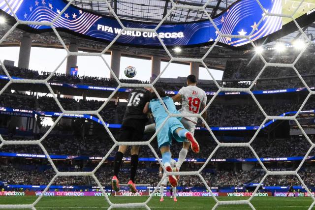 Iran's goalkeeper #01 Alireza Beiranvand clears the ball past New Zealand's defender #16 Finn Surman and Iran's defender #19 Ali Nemati during the 2026 World Cup Group G football match between Iran and New Zealand at Los Angeles Stadium in Inglewood on June 15, 2026.  (Photo by Patrick T. Fallon / AFP)