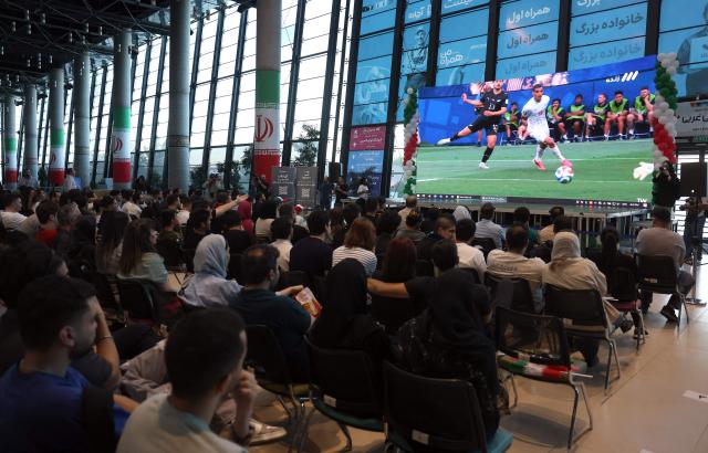 Iranians watch the 2026 World Cup football tournament match between Iran and New Zealand at Tehran Book Garden in Tehran, Iran, on June 16, 2026. (Photo by AFP)