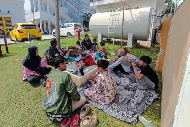 Patients and their family members evacuate outside Anutapura General Hospital following a 6.7 magnitude earthquake in Palu, Central Sulawesi, on June 16, 2026. A shallow 6.7 magnitude earthquake struck central Indonesia on June 16, the US Geological Survey said, with no immediate reports of casualties or damage. (Photo by MUHAMMAD RIFKI / AFP)