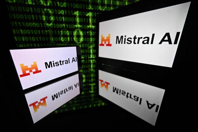 (FILES) This photograph shows screens displaying the logo of the French articial intelligence Mistral AI company, and a binary code in the background, in Toulouse, southwestern France on September 9, 2025. The government is set to roll out an AI chatbot to around one million civil servants, after a trial with 10,000 users, the Ministry of Public Action and Accounts announced on June 16, 2026. Powered by models from French start-up Mistral, the tool will be deployed at an estimated cost of Ђ700,000, including access to Mistral’s technology. (Photo by Lionel BONAVENTURE / AFP)