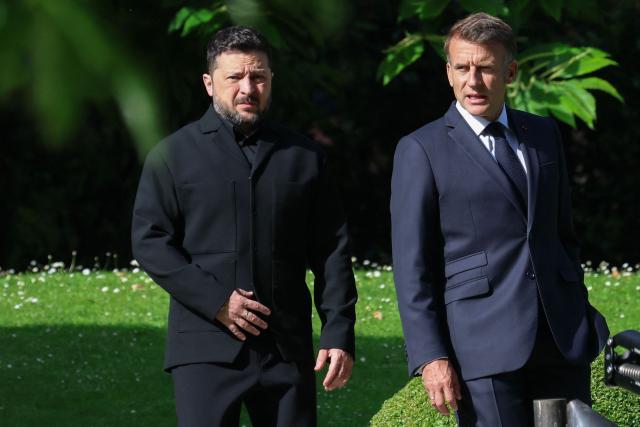 France's President Emmanuel Macron greets Ukraine's President Volodymyr Zelensky ahead of the working session with G7 leaders and Ukraine during the G7 summit, in Evian, eastern France, on June 16, 2026. A G7 summit is set to take place June 15 to 17 in the French town of Evian-les-Bains near Switzerland and it will be attended by country leaders as well as the EU's foreign policy chief and ministers from Brazil, Canada, the United Arab Emirates and Turkey. (Photo by Ludovic MARIN / AFP)