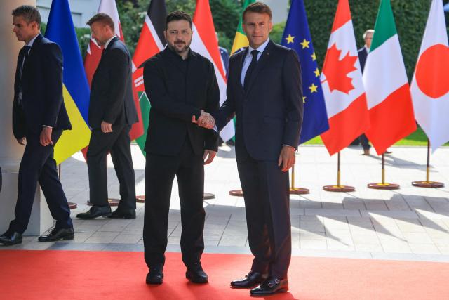 France's President Emmanuel Macron greets Ukraine's President Volodymyr Zelensky ahead of the working session with G7 leaders and Ukraine during the G7 summit, in Evian, eastern France, on June 16, 2026. A G7 summit is set to take place June 15 to 17 in the French town of Evian-les-Bains near Switzerland and it will be attended by country leaders as well as the EU's foreign policy chief and ministers from Brazil, Canada, the United Arab Emirates and Turkey. (Photo by Ludovic MARIN / AFP)