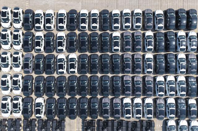 Chinese-manufactured Volkswagen cars are seen on a dock at the International Automobile Trade Port in the Hangzhou section of the Beijing-Hangzhou Grand Canal, in Hangzhou, in China’s eastern Zhejiang province, before being transported to another port from where they will be exported, on June 15, 2026. (Photo by CN-STR / AFP) / China OUT