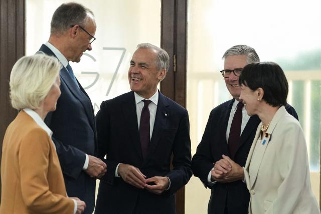 (From L) European Commission President Ursula von der Leyen, Germany's Chancellor Friedrich Merz, Canada's Prime Minister Mark Carney, Britain's Prime Minister Keir Starmer and Japan's Prime Minister Sanae Takaichi react during a working session at the G7 summit in Evian-les-Bains, central-eastern France on June 16, 2026. (Photo by Thibault Camus / POOL / AFP)