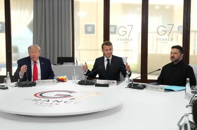 (From L) US President Donald Trump, France's President Emmanuel Macron and Ukraine's President Volodymyr Zelensky take part in a working session at the G7 summit in Evian-les-Bains, central-eastern France on June 16, 2026. (Photo by Thibault Camus / POOL / AFP)