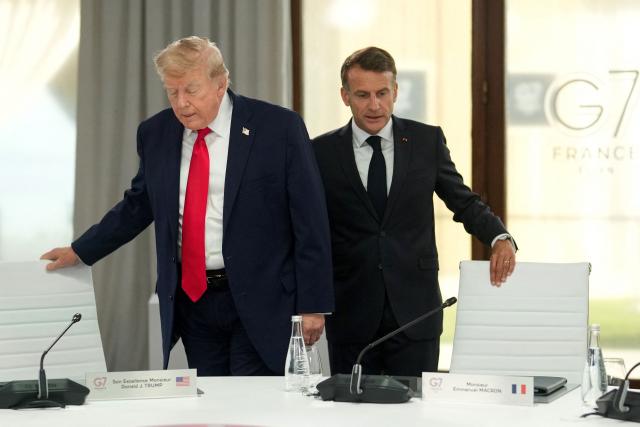 US President Donald Trump (L) and France's President Emmanuel Macron arrive to take part in a working session at the G7 summit in Evian-les-Bains, central-eastern France on June 16, 2026. (Photo by Thibault Camus / POOL / AFP)