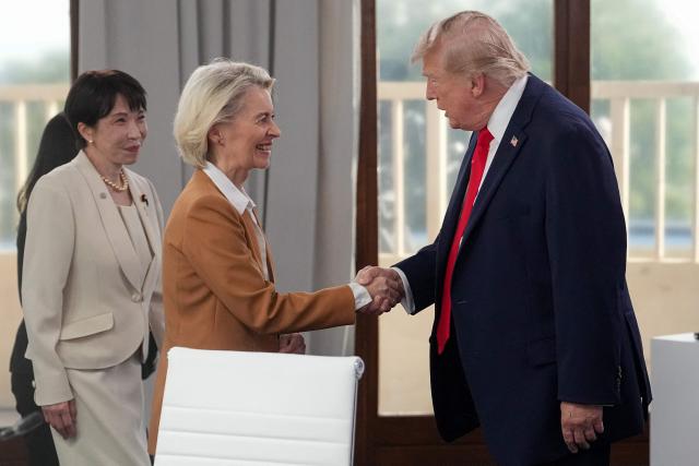 US President Donald Trump (R) shakes hands with European Commission President Ursula von der Leyen (C) next to Japan's Prime Minister Sanae Takaichi prior to a working session at the G7 summit in Evian-les-Bains, central-eastern France on June 16, 2026. (Photo by Thibault Camus / POOL / AFP)