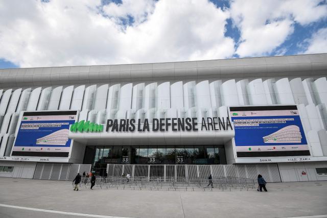 (FILES) This picture taken on May 3, 2021 shows a general view of the entrance of the Covid-19 vaccination centre in Paris La Defense Arena stadium in Nanterre, west of Paris. Paris La Defense Arena, Europe’s largest indoor venue will be renamed Plenitude Arena from July 1, 2026, following the signing of a contract with this subsidiary of Eni, the Italian energy giant. Naming rights are a marketing practice that allows a company to have its name attached to a sports venue or event in exchange for a financial contribution. (Photo by Bertrand GUAY / AFP)