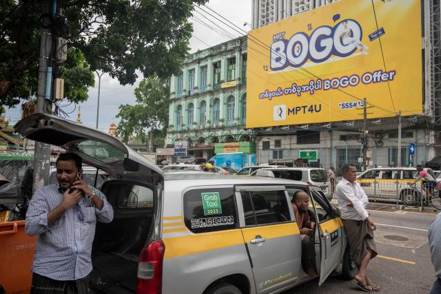 Taxi drivers wait for passengers in Yangon on June 16, 2026. (Photo by Sai Aung MAIN / AFP)