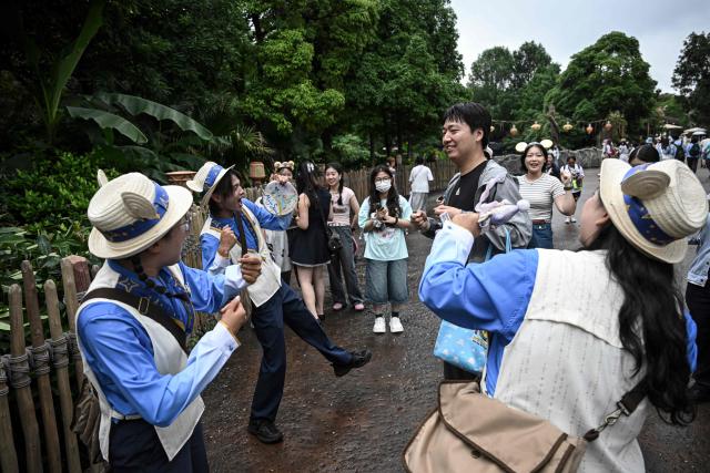 Disney cast members interact with visitors at Shanghai Disney Resort in Shanghai on June 16, 2026 (Photo by Jade Gao / AFP)