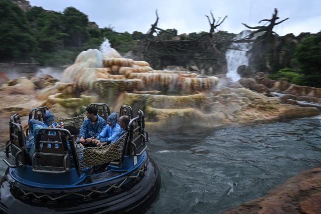 Visitors ride the 'Roaring Rapids' at Shanghai Disney Resort in Shanghai on June 16, 2026. (Photo by Jade Gao / AFP)