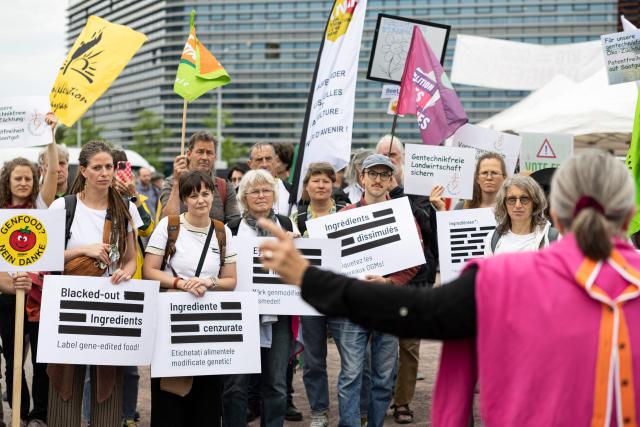 Farmers and demonstrators hold placards reading "Blacked-out ingredients - Label gene-edited food !" as they gather in front of the European Parliament during a demonstration to call MEPs to vote against a proposal to deregulate genetically modified organisms, in Strasbourg, eastern France on June 16, 2026. (Photo by ROMEO BOETZLE / AFP)
