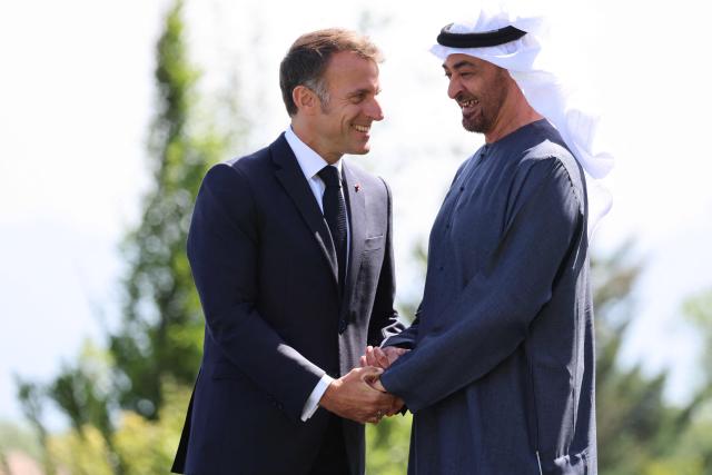 France's President Emmanuel Macron (L) welcomes United Arab Emirates' Crown prince Mohammed Bin Zayed Al Nahyan for the official greeting ahead of a work lunch as part of the G7 summit, in Evian, eastern France, on June 16, 2026. A G7 summit is set to take place June 15 to 17 in the French town of Evian-les-Bains near Switzerland and it will be attended by country leaders as well as the EU's foreign policy chief and ministers from Brazil, Canada, the United Arab Emirates and Turkey. (Photo by Ludovic MARIN / AFP)