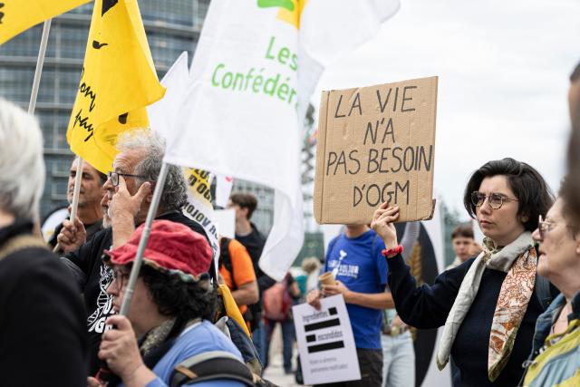 A demonstrator holds a placard reading "Life doesn't need GMO" as protestors gather in front of the European Parliament during a demonstration to call MEPs to vote against a proposal to deregulate genetically modified organisms, in Strasbourg, eastern France on June 16, 2026. (Photo by ROMEO BOETZLE / AFP)