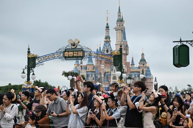 Visitors watch a parade at Shanghai Disney Resort in Shanghai on June 16, 2026. (Photo by Jade Gao / AFP)