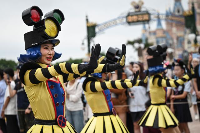 Disney cast members perform during a parade at Shanghai Disney Resort in Shanghai on June 16, 2026. (Photo by Jade Gao / AFP)