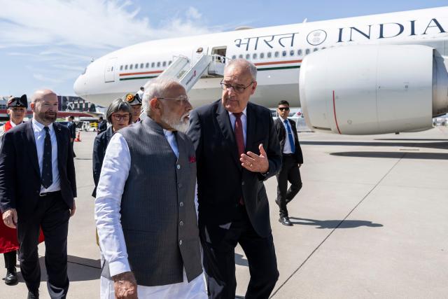 Switzerland's President Guy Parmelin welcomes India's Prime Minister Narendra Modi as he arrives to attend the G7 summit, at Geneva Airport on June 16, 2026. A G7 summit is set to take place June 15 to 17 in the French town of Evian-les-Bains near Switzerland and it will be attended by country leaders as well as the EU's foreign policy chief and ministers from Brazil, Canada, the United Arab Emirates and Turkey. (Photo by MARTIAL TREZZINI / POOL / AFP)