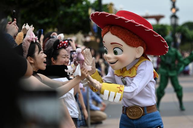 Toy Story character Jessie interacts with visitors during a parade at Shanghai Disney Resort in Shanghai on June 16, 2026. (Photo by Jade Gao / AFP)
