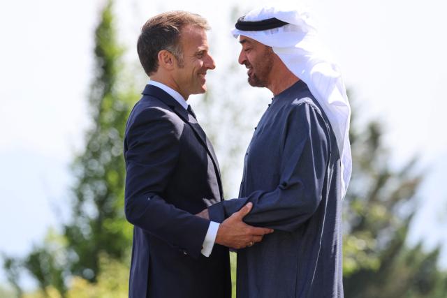 France's President Emmanuel Macron (L) welcomes United Arab Emirates' Crown prince Mohammed Bin Zayed Al Nahyan for the official greeting ahead of a work lunch as part of the G7 summit, in Evian, eastern France, on June 16, 2026. A G7 summit is set to take place June 15 to 17 in the French town of Evian-les-Bains near Switzerland and it will be attended by country leaders as well as the EU's foreign policy chief and ministers from Brazil, Canada, the United Arab Emirates and Turkey. (Photo by Ludovic MARIN / AFP)