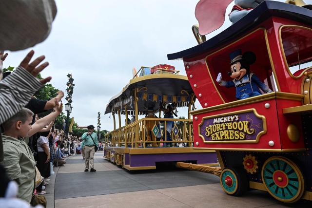 Disney character Mickey Mouse waves to visitors during a parade at Shanghai Disney Resort in Shanghai on June 16, 2026. (Photo by Jade Gao / AFP)