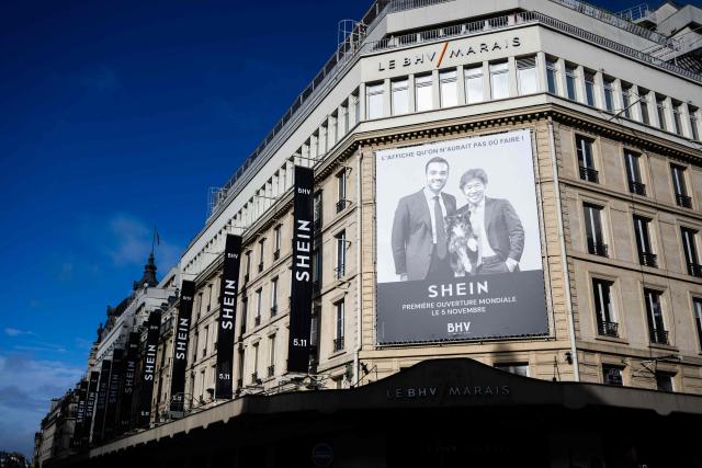 (FILES) This photograph shows a sign with an advertising picture of president of French real estate group the Societe des Grands Magasins (SGM), and owner of BHV, Frederic Merlin (L), and of Chinese and US businessman and Executive Chairman of Shein Group, Donald Tang, on the facade of the Bazar de l'Hotel de Ville (BHV) department store in Paris on November 3, 2025, just days before Shein opens its first physical store at BHV in Paris. SGM, co-founded by Frйdйric Merlin, announced on June 16, 2026, that it would sell the business assets of BHV Marais to the Paris department store’s “management team,” which has decided to “put an end” to its much-criticized partnership with Shein, considered a “strategic mistake". (Photo by Julie SEBADELHA / AFP)