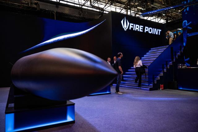 Visitors walk at the stand of Ukrainian defence technology company Fire Point during the Eurosatory land and airland defence and security trade fair, at the Paris-Nord Villepinte Exhibition Centre in Villepinte, north of Paris on June 15, 2026. (Photo by Guillaume BAPTISTE / AFP)