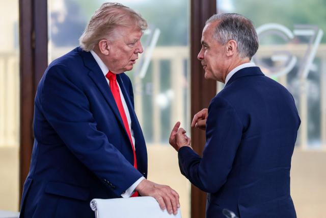US President Donald Trump speaks with Canada's Prime Minister Mark Carney during a work lunch as part of the G7 summit, in Evian, eastern France, on June 16, 2026. A G7 summit is set to take place June 15 to 17 in the French town of Evian-les-Bains near Switzerland and it will be attended by country leaders as well as the EU's foreign policy chief and ministers from Brazil, Canada, the United Arab Emirates and Turkey. (Photo by Evelyn Hockstein / POOL / AFP)