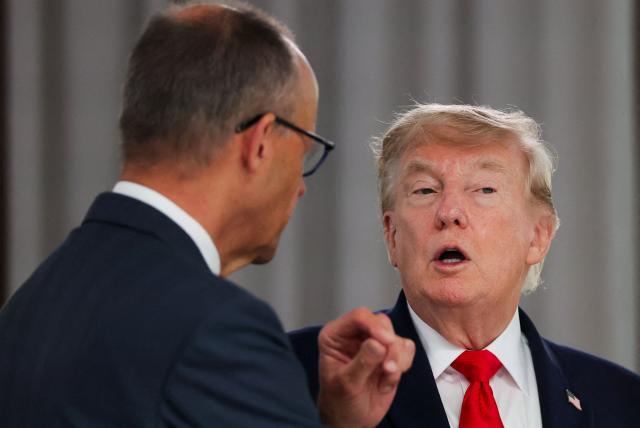 US President Donald Trump speaks with Germany's Chancellor Friedrich Merz during a work lunch as part of the G7 summit, in Evian, eastern France, on June 16, 2026. A G7 summit is set to take place June 15 to 17 in the French town of Evian-les-Bains near Switzerland and it will be attended by country leaders as well as the EU's foreign policy chief and ministers from Brazil, Canada, the United Arab Emirates and Turkey. (Photo by Christian Hartmann / POOL / AFP)