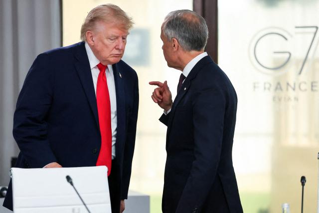 US President Donald Trump (L) speaks with Canada's Prime Minister Mark Carney during a work lunch as part of the G7 summit, in Evian, eastern France, on June 16, 2026. A G7 summit is set to take place June 15 to 17 in the French town of Evian-les-Bains near Switzerland and it will be attended by country leaders as well as the EU's foreign policy chief and ministers from Brazil, Canada, the United Arab Emirates and Turkey. (Photo by Christian Hartmann / POOL / AFP)