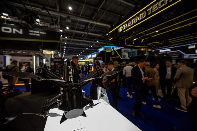 Visitors stand next to a P1-Sun interceptor drone displayed by Ukraine-based military technology startup specializing in unmanned aerial systems during the Eurosatory land and airland defence and security trade fair, at the Paris-Nord Villepinte Exhibition Centre in Villepinte, north of Paris on June 15, 2026. (Photo by Guillaume BAPTISTE / AFP)