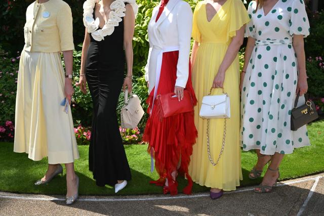 Racegoers pose for a photograph as they arrive on the first day of the Royal Ascot horse racing meeting in Ascot, west of London, on June 16, 2026. (Photo by JUSTIN TALLIS / AFP)