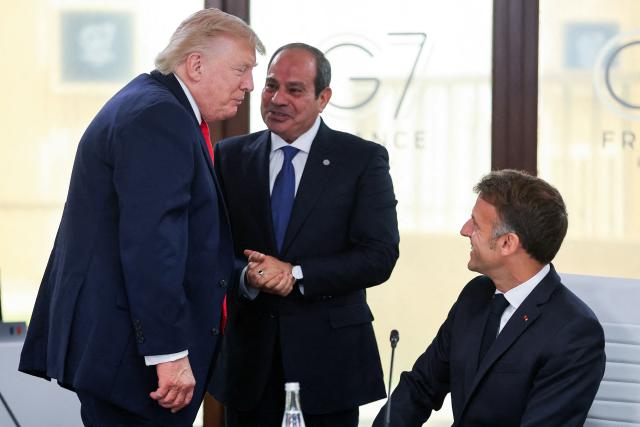 (From L) US President Donald Trump speaks with Egypt's President Abdel Fattah al-Sisi and France's President Emmanuel Macron during a work lunch as part of the G7 summit, in Evian, eastern France, on June 16, 2026. A G7 summit is set to take place June 15 to 17 in the French town of Evian-les-Bains near Switzerland and it will be attended by country leaders as well as the EU's foreign policy chief and ministers from Brazil, Canada, the United Arab Emirates and Turkey. (Photo by Christian Hartmann / POOL / AFP)